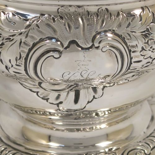 A rare and very pretty Antique Georgian George II Sterling Silver small rose bowl, having a round body with hand-chased floral decoration surrounding two cartouches on either side, and sitting on a round pedestal foot. This beautiful antique silver bowl was made by Thomas Whipham and Charles Wright of London in 1758. The dimensions of this fine hand-made antique silver rose bowl are height 9.5 cms (3.75 inches), diameter 12.5 cms (5 inches), with a weight of approx. 271g (8.7 troy ounces). Please note that one of the cartouches is engraved with a contemporaneous set of initials.