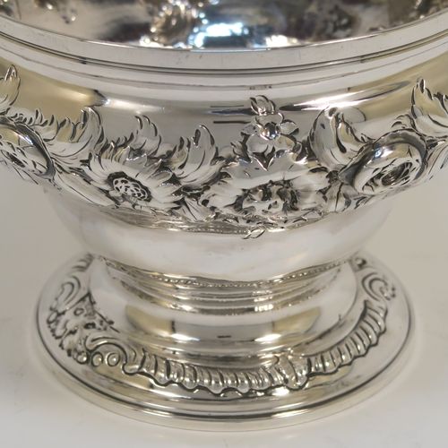 A rare and very pretty Antique Georgian George II Sterling Silver small rose bowl, having a round body with hand-chased floral decoration surrounding two cartouches on either side, and sitting on a round pedestal foot. This beautiful antique silver bowl was made by Thomas Whipham and Charles Wright of London in 1758. The dimensions of this fine hand-made antique silver rose bowl are height 9.5 cms (3.75 inches), diameter 12.5 cms (5 inches), with a weight of approx. 271g (8.7 troy ounces). Please note that one of the cartouches is engraved with a contemporaneous set of initials.