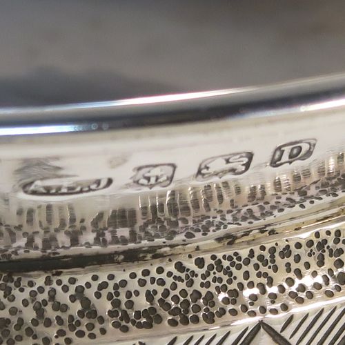 An Arts and Crafts style Sterling Silver & wood Mazer bowl, having a plain round plenished or hand-hammered body, mounted on an Oak base, and having an applied central Celtic style band. This beautiful silver Mazer bowl was made by A. E. Jones of Birmingham in 1928. The dimensions of this fine hand-made wood & silver Mazer bowl are diameter 14 cms (5.5 inches), and height 6.5 cms (2.5 inches). We cannot give a total weight because of the wooden base, but the gauge of silver used is very good.