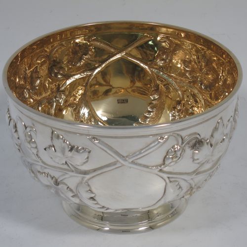 A very pretty Antique Victorian Sterling Silver rose bowl, having a round body with hand-chased fruit and floral decoration surrounding two vacant cartouches, a gold-gilt interior, and sitting on a collet foot. Made by Martin and Hall of Sheffield in in 1863. The dimensions of this fine hand-made antique silver rose bowl are height 7.5 cms (3 inches), diameter 11.5 cms (4.5 inches), with a weight of approx. 165g (5.3 troy ounces).   