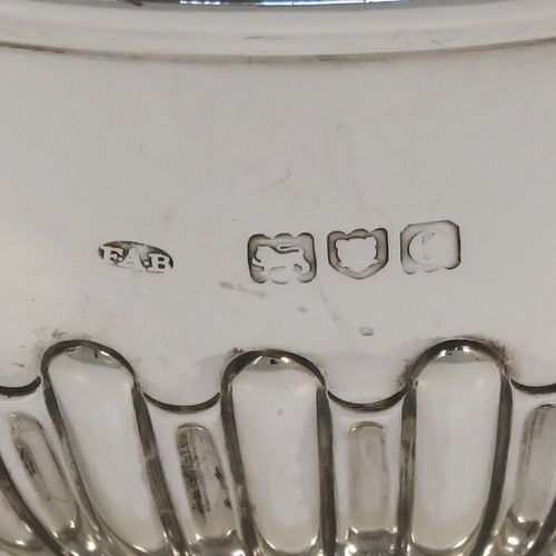 A very handsome Antique Victorian Sterling Silver small Rose bowl, having a round body with hand-chased half-fluted decoration, an applied reeded top border, and sitting on a round pedestal foot. This elegant antique silver rose bowl was made by Frederick Burridge of London in 1898. The dimensions of this fine hand-made silver bowl are height 8.5 cms (3.3 inches), diameter 13.5 cms (5.3 inches), and it weighs approx. 178g (5.7 troy ounces).