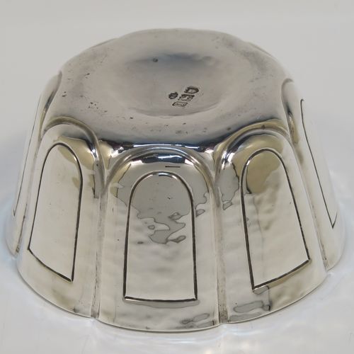 A heavy and handsome Antique Edwardian Sterling Silver small bowl, having a round bellied body with a hand-hammered finish, together with hand-chased panel decoration, and all sitting on a concave base. This elegant antique silver bowl was made by the William Comyns of London in 1904. The dimensions of this fine hand-made silver bowl are height 5 cms (2 inches), diameter 10 cms (4 inches), and it weighs approx. 222g (7.2 troy ounces).