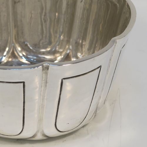 A heavy and handsome Antique Edwardian Sterling Silver small bowl, having a round bellied body with a hand-hammered finish, together with hand-chased panel decoration, and all sitting on a concave base. This elegant antique silver bowl was made by the William Comyns of London in 1904. The dimensions of this fine hand-made silver bowl are height 5 cms (2 inches), diameter 10 cms (4 inches), and it weighs approx. 222g (7.2 troy ounces).