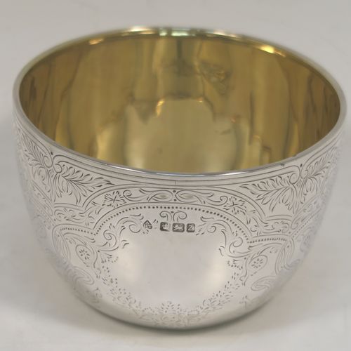 A very pretty Antique Victorian Sterling Silver bowl, having a round body with hand-engraved floral and scroll-work decoration, a gold-gilt interior, and sitting on a flat base. This beautiful antique silver bowl was made by Albert Henry Thompson of Sheffield in 1892. The dimensions of this fine hand-made antique silver bowl are height 6.5 cms (2.75 inches), diameter 10 cms (4 inches), and it weighs approx. 132g (4.3 troy ounces).

   