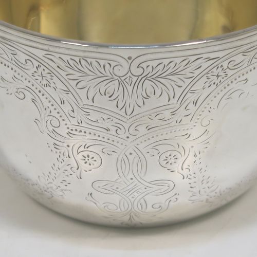A very pretty Antique Victorian Sterling Silver bowl, having a round body with hand-engraved floral and scroll-work decoration, a gold-gilt interior, and sitting on a flat base. This beautiful antique silver bowl was made by Albert Henry Thompson of Sheffield in 1892. The dimensions of this fine hand-made antique silver bowl are height 6.5 cms (2.75 inches), diameter 10 cms (4 inches), and it weighs approx. 132g (4.3 troy ounces).