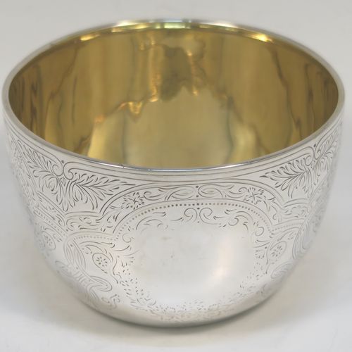 A very pretty Antique Victorian Sterling Silver bowl, having a round body with hand-engraved floral and scroll-work decoration, a gold-gilt interior, and sitting on a flat base. This beautiful antique silver bowl was made by Albert Henry Thompson of Sheffield in 1892. The dimensions of this fine hand-made antique silver bowl are height 6.5 cms (2.75 inches), diameter 10 cms (4 inches), and it weighs approx. 132g (4.3 troy ounces).