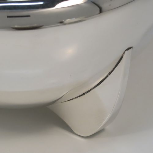 A handsome Art Deco style Sterling Silver bowl, having a very plain round body with tapering sides and folded over rim, sitting on three fin-style panelled feet. This elegant silver bowl was made by James Round of Sheffield in 1934. The dimensions of this fine hand-made Art Deco silver bowl are diameter 15 cms (6 inches), height 9 cms (3.5 inches), and it weighs approx. 218g (7 troy ounces).