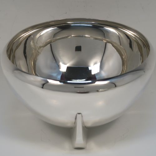 A handsome Art Deco style Sterling Silver bowl, having a very plain round body with tapering sides and folded over rim, sitting on three fin-style panelled feet. This elegant silver bowl was made by James Round of Sheffield in 1934. The dimensions of this fine hand-made Art Deco silver bowl are diameter 15 cms (6 inches), height 9 cms (3.5 inches), and it weighs approx. 218g (7 troy ounces).