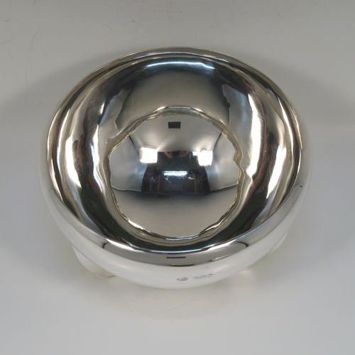 A handsome Art Deco style Sterling Silver bowl, having a very plain round body with tapering sides and folded over rim, sitting on three fin-style panelled feet. This elegant silver bowl was made by James Round of Sheffield in 1934. The dimensions of this fine hand-made Art Deco silver bowl are diameter 15 cms (6 inches), height 9 cms (3.5 inches), and it weighs approx. 218g (7 troy ounces).