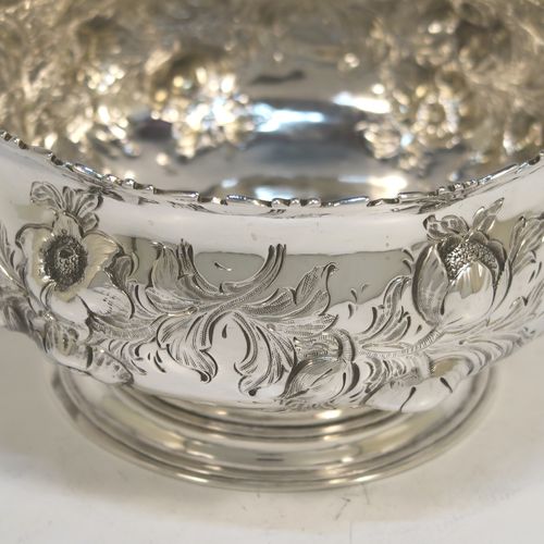 A very pretty Antique Victorian Sterling Silver small rose bowl, having a round body with hand-chased fruit and floral decoration surrounding two vacant cartouches on either side, and sitting on a pedestal foot. This beautiful antique silver bowl was made by Daniel and Charles Houle of London in 1856. The dimensions of this fine hand-made antique silver rose bowl are height 7.5 cms (3 inches), diameter 12.5 cms (5 inches), with a weight of approx. 262g (8.5 troy ounces).