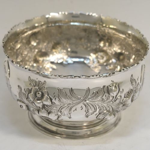 A very pretty Antique Victorian Sterling Silver small rose bowl, having a round body with hand-chased fruit and floral decoration surrounding two vacant cartouches on either side, and sitting on a pedestal foot. This beautiful antique silver bowl was made by Daniel and Charles Houle of London in 1856. The dimensions of this fine hand-made antique silver rose bowl are height 7.5 cms (3 inches), diameter 12.5 cms (5 inches), with a weight of approx. 262g (8.5 troy ounces).
