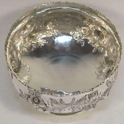 A very pretty Antique Victorian Sterling Silver small rose bowl, having a round body with hand-chased fruit and floral decoration surrounding two vacant cartouches on either side, and sitting on a pedestal foot. This beautiful antique silver bowl was made by Daniel and Charles Houle of London in 1856. The dimensions of this fine hand-made antique silver rose bowl are height 7.5 cms (3 inches), diameter 12.5 cms (5 inches), with a weight of approx. 262g (8.5 troy ounces).