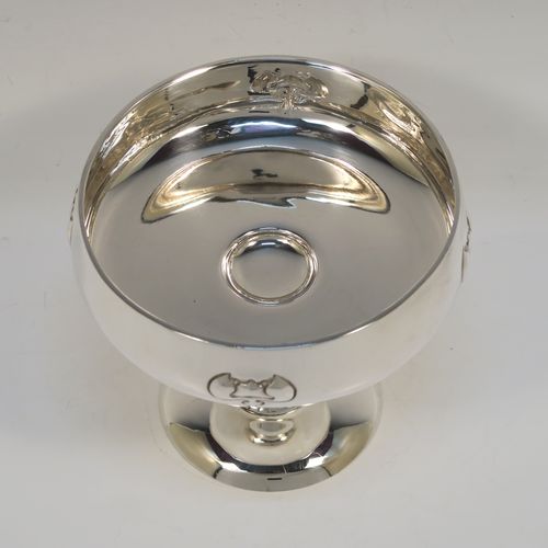 A very pretty Antique Edwardian Sterling Silver Arts & Crafts style bowl, having a round bellied body with hand-chased Lilly style decoration, and sitting on a matching round pedestal foot. This beautiful raised table bowl was made by A. and J. Zimmerman of Birmingham in 1904. The dimensions of this fine hand-made antique silver bowl are height 11 cms (4.3 inches), diameter 13 cms (5 inches), and it weighs approx. 171g (5.5 troy ounces).