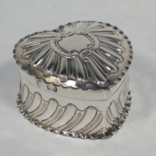 A very pretty Antique Victorian Sterling Silver heart-shaped table box, having a gold-gilt interior, all hand-chased with scroll-work, a hinged lid with vacant cartouche, and all sitting on a flat base. Made by Streeter and Co. Ltd., of London in 1899. The dimensions of this fine hand-made antique silver box are length 6 cms (2.3 inches), width 6 cms (2.3 inches), height 4 cms (1.5 inches), and it weighs approx. 49g (1.6 troy ounces).    