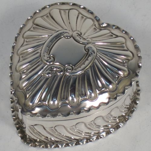 A very pretty Antique Victorian Sterling Silver heart-shaped table box, having a gold-gilt interior, all hand-chased with scroll-work, a hinged lid with vacant cartouche, and all sitting on a flat base. Made by Streeter and Co. Ltd., of London in 1899. The dimensions of this fine hand-made antique silver box are length 6 cms (2.3 inches), width 6 cms (2.3 inches), height 4 cms (1.5 inches), and it weighs approx. 49g (1.6 troy ounces).