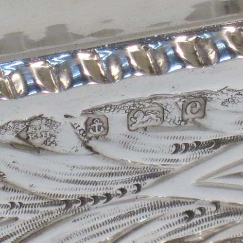 A bold and very pretty Antique Edwardian Sterling Silver Art Nouveau style table box, having a rounded rectangular body with hand-chased floral and scroll decoration, with crimped bead-edged borders and a gold-gilt interior, a hinged lid, and sitting on a flat base. Made by Nathan & Hayes of Birmingham in 1904. The dimensions of this fine hand-made antique silver Art Nouveau style box are length 20 cms (8 inches), width 6 cms (2.3 inches), height 5 cms (2 inches), and it weighs approx. 160g (5.2 troy ounces).