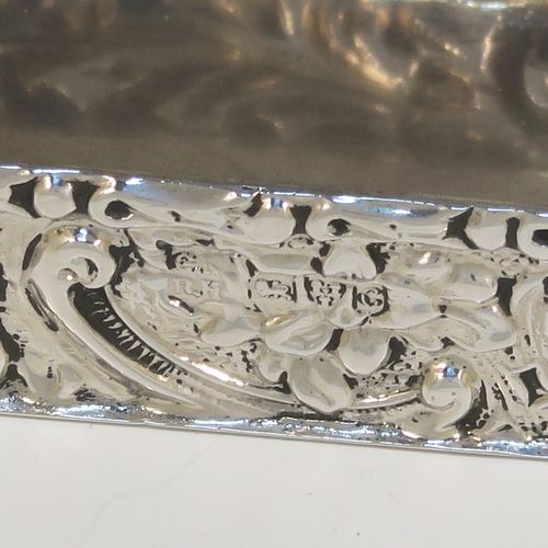 A beautiful Antique Edwardian Sterling Silver table box, having a rectangular body with hand-chased floral and scroll decoration, a hinged lid with a hand-chased figural scene and an applied thumb-piece, the remains of a gold-gilt interior, and sitting on a flat base. This pretty antique silver box was made by Nathan and Hayes of Chester in 1903. The dimensions of this fine hand-made antique sterling silver box are length 9 cms (3.5 inches), width 4 cms (1.5 inches), height 2 cms (0.75 inches), and it weighs approx. 54g (1.7 troy ounces).