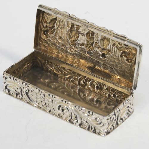 A beautiful Antique Edwardian Sterling Silver table box, having a rectangular body with hand-chased floral and scroll decoration, a hinged lid with a hand-chased figural scene and an applied thumb-piece, the remains of a gold-gilt interior, and sitting on a flat base. This pretty antique silver box was made by Nathan and Hayes of Chester in 1903. The dimensions of this fine hand-made antique sterling silver box are length 9 cms (3.5 inches), width 4 cms (1.5 inches), height 2 cms (0.75 inches), and it weighs approx. 54g (1.7 troy ounces).