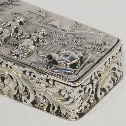 A beautiful Antique Edwardian Sterling Silver table box, having a rectangular body with hand-chased floral and scroll decoration, a hinged lid with a hand-chased figural scene and an applied thumb-piece, the remains of a gold-gilt interior, and sitting on a flat base. This pretty antique silver box was made by Nathan and Hayes of Chester in 1903. The dimensions of this fine hand-made antique sterling silver box are length 9 cms (3.5 inches), width 4 cms (1.5 inches), height 2 cms (0.75 inches), and it weighs approx. 54g (1.7 troy ounces).