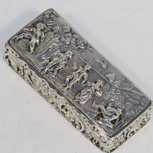 A beautiful Antique Edwardian Sterling Silver table box, having a rectangular body with hand-chased floral and scroll decoration, a hinged lid with a hand-chased figural scene and an applied thumb-piece, the remains of a gold-gilt interior, and sitting on a flat base. This pretty antique silver box was made by Nathan and Hayes of Chester in 1903. The dimensions of this fine hand-made antique sterling silver box are length 9 cms (3.5 inches), width 4 cms (1.5 inches), height 2 cms (0.75 inches), and it weighs approx. 54g (1.7 troy ounces).