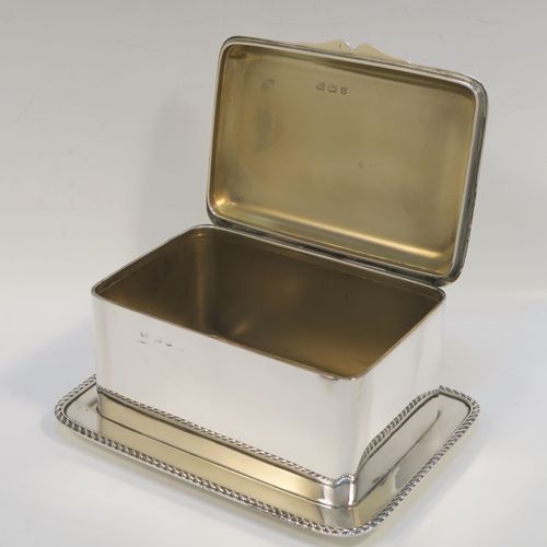 A very elegant Antique Victorian Sterling Silver table box, having a rectangular body, with hinged lid and thumb-piece, a gold-gilt interior, with an attached plate with gadroon border and sitting on a flat base. This handsome silver box was made by Heath and Middleton of Birmingham in 1897. The dimensions of this fine hand-made antique silver table box are length 17 cms (6.75 inches), width 12.5 cms (5 inches), height 8 cms (3 inches), and it weighs approx. 547g (17.6 troy ounces)