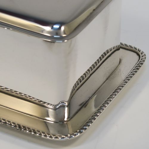 A very elegant Antique Victorian Sterling Silver table box, having a rectangular body, with hinged lid and thumb-piece, a gold-gilt interior, with an attached plate with gadroon border and sitting on a flat base. This handsome silver box was made by Heath and Middleton of Birmingham in 1897. The dimensions of this fine hand-made antique silver table box are length 17 cms (6.75 inches), width 12.5 cms (5 inches), height 8 cms (3 inches), and it weighs approx. 547g (17.6 troy ounces)
