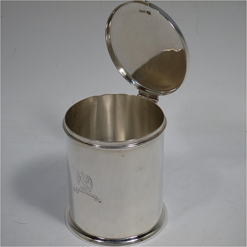 A very handsome Sterling Silver table box, having a round and straight-sided body with a hinged and slightly domed lid, with applied reed borders and thumb-piece, and sitting on a collet foot. Made by Ollivant and Bottisford of Sheffield in 1931. The dimensions of this fine hand-made silver box are diameter 8 cms (3 inches), height 9 cms (3.5 inches), and it weighs approx. 276g (8.9 troy ounces). Please note that this item is crested.