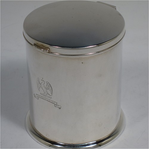 A very handsome Sterling Silver table box, having a round and straight-sided body with a hinged and slightly domed lid, with applied reed borders and thumb-piece, and sitting on a collet foot. Made by Ollivant and Bottisford of Sheffield in 1931. The dimensions of this fine hand-made silver box are diameter 8 cms (3 inches), height 9 cms (3.5 inches), and it weighs approx. 276g (8.9 troy ounces). Please note that this item is crested.