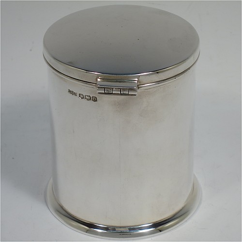 A very handsome Sterling Silver table box, having a round and straight-sided body with a hinged and slightly domed lid, with applied reed borders and thumb-piece, and sitting on a collet foot. Made by Ollivant and Bottisford of Sheffield in 1931. The dimensions of this fine hand-made silver box are diameter 8 cms (3 inches), height 9 cms (3.5 inches), and it weighs approx. 276g (8.9 troy ounces). Please note that this item is crested.