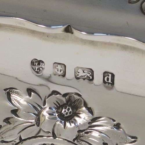 A very pretty Antique Edwardian Sterling Silver table box, having a square bellied body with hand-chased floral and scroll decoration, a hinged lid with matching decoration, a gold gilt interior, and sitting on four cast foliate and scroll feet. This beautiful antique silver box was made by Williams Ltd., of Birmingham in 1903. The dimensions of this fine hand-made silver box are 12.5 cms (5 inches) square, height 7.5 cms (3 inches), and it weighs approx. 328g (10.6 troy ounces).
