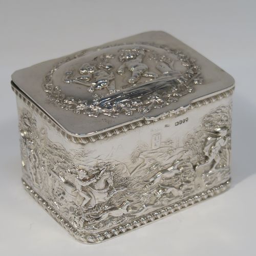 A beautiful Antique Victorian Sterling Silver table box, having a rectangular body with hand-chased figural hunting scenes and applied gadroon borders, a hinged lid with hand-chased grapevine and dancing cherubs, a gold-gilt interior, and sitting on a flat base. This very pretty antique sterling silver box has in importers mark for 1900. The dimensions of this fine hand-made antique silver box are length 9.5 cms (3.75 inches), width 7.5 cms (3 inches), height 6.5 cms (2.6 inches), and it weighs approx. 168g (5.4 troy ounces).   