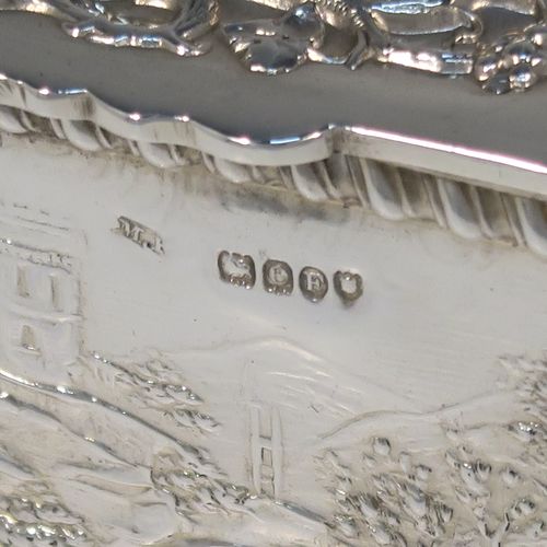 A beautiful Antique Victorian Sterling Silver table box, having a rectangular body with hand-chased figural hunting scenes and applied gadroon borders, a hinged lid with hand-chased grapevine and dancing cherubs, a gold-gilt interior, and sitting on a flat base. This very pretty antique sterling silver box has in importers mark for 1900. The dimensions of this fine hand-made antique silver box are length 9.5 cms (3.75 inches), width 7.5 cms (3 inches), height 6.5 cms (2.6 inches), and it weighs approx. 168g (5.4 troy ounces).