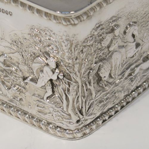 A beautiful Antique Victorian Sterling Silver table box, having a rectangular body with hand-chased figural hunting scenes and applied gadroon borders, a hinged lid with hand-chased grapevine and dancing cherubs, a gold-gilt interior, and sitting on a flat base. This very pretty antique sterling silver box has in importers mark for 1900. The dimensions of this fine hand-made antique silver box are length 9.5 cms (3.75 inches), width 7.5 cms (3 inches), height 6.5 cms (2.6 inches), and it weighs approx. 168g (5.4 troy ounces).