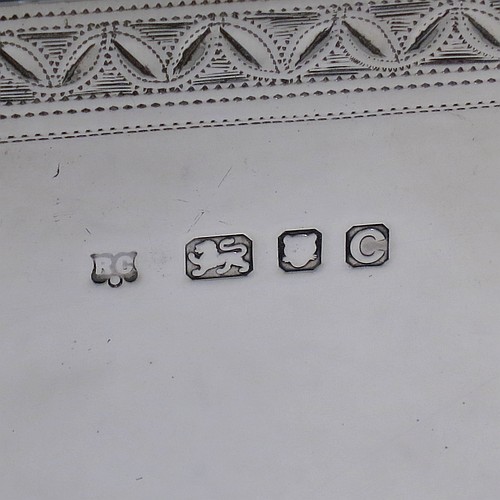 A very fine, unusual, and handsome heavy Sterling Silver table box, having a cube-shaped body, with an invisibly hinged lid, and hand-engraved with bright-cut floral leaf-work borders, and sitting on a flat base. Beautifully and skilfully hand-made made by Robert Comyns of London in 1938. The dimensions of this fine hand-made silver box are 11.5 cms (4.5 inches) cubed, and it weighs approx. 890g (29 troy ounces).