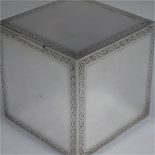A very fine, unusual, and handsome heavy Sterling Silver table box, having a cube-shaped body, with an invisibly hinged lid, and hand-engraved with bright-cut floral leaf-work borders, and sitting on a flat base. Beautifully and skilfully hand-made made by Robert Comyns of London in 1938. The dimensions of this fine hand-made silver box are 11.5 cms (4.5 inches) cubed, and it weighs approx. 890g (29 troy ounces).