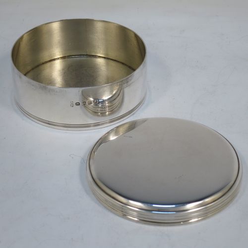 A very handsome Antique Georgian Sterling Silver very plain round table box, having a lift-off slightly lid, with reeded borders, and sitting on a flat base. Made by William Parker of London in 1818. The dimensions of this fine hand-made antique silver box are diameter 9 cms (3.5 inches), height 4 cms (1.5 inches), and it weighs approx. 191g (6.2 troy ounces).  