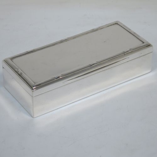 A very handsome Antique Edwardian Sterling Silver table box, having a plain rectangular body, a hinged lid having an applied ribbon and reed border and thumb-piece, and sitting on a flat base. Made by Goldsmiths and Silversmiths of London in 1907. The dimensions of this fine hand-made antique silver table box are length 11.5 cms (4.5 inches), width 5 cms (2 inches), height 3 cms (1.25 inch), and it weighs approx. 148g (4.8 troy ounces).   
