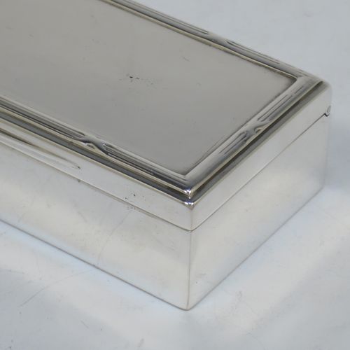 A very handsome Antique Edwardian Sterling Silver table box, having a plain rectangular body, a hinged lid having an applied ribbon and reed border and thumb-piece, and sitting on a flat base. Made by Goldsmiths and Silversmiths of London in 1907. The dimensions of this fine hand-made antique silver table box are length 11.5 cms (4.5 inches), width 5 cms (2 inches), height 3 cms (1.25 inch), and it weighs approx. 148g (4.8 troy ounces).
