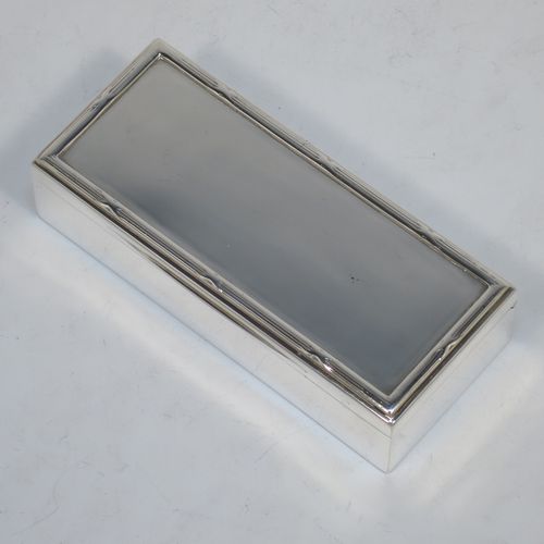 A very handsome Antique Edwardian Sterling Silver table box, having a plain rectangular body, a hinged lid having an applied ribbon and reed border and thumb-piece, and sitting on a flat base. Made by Goldsmiths and Silversmiths of London in 1907. The dimensions of this fine hand-made antique silver table box are length 11.5 cms (4.5 inches), width 5 cms (2 inches), height 3 cms (1.25 inch), and it weighs approx. 148g (4.8 troy ounces).
