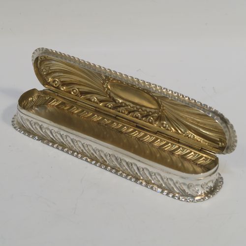 A beautiful Antique Victorian Sterling Silver Art Nouveau style table box, having a rounded rectangular body with hand-chased fluted and scroll decoration, with crimped bead-edged borders and a gold-gilt interior, a hinged lid with a vacant oval cartouche, and sitting on a flat base. This pretty antique silver box was made by Gibson and Langland of London in 1898. The dimensions of this fine hand-made antique silver Art Nouveau style box are length 17.5 cms (7 inches), width 5 cms (2 inches), height 2.5 cms (1 inch), and it weighs approx. 142g (4.6 troy ounces).