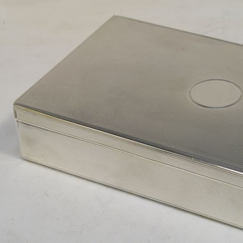 A very elegant Antique Victorian Sterling Silver table or desk box, having a rectangular body with engine-turned decoration, a vacant round cartouche on the hinged lid, a compartmentalised interior, and all sitting of a flat base. This handsome antique silver box was made by Charles and George Asprey of London in 1896. The dimensions of this fine hand-made antique silver table box are length 18.5 cms (7.25 inches), width 11 cms (4.25 inches), height 3.5 cms (1.3 inches), and it weighs approx. 569g (18.4 troy ounces)