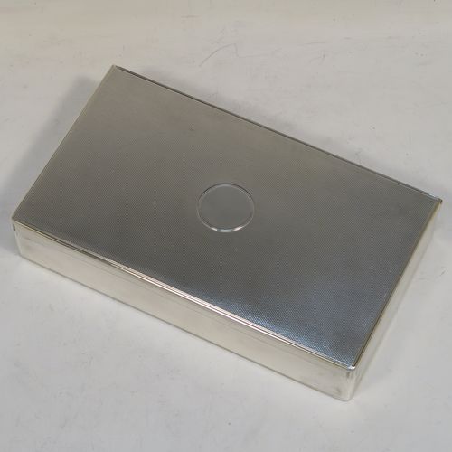 A very elegant Antique Victorian Sterling Silver table or desk box, having a rectangular body with engine-turned decoration, a vacant round cartouche on the hinged lid, a compartmentalised interior, and all sitting of a flat base. This handsome antique silver box was made by Charles and George Asprey of London in 1896. The dimensions of this fine hand-made antique silver table box are length 18.5 cms (7.25 inches), width 11 cms (4.25 inches), height 3.5 cms (1.3 inches), and it weighs approx. 569g (18.4 troy ounces)