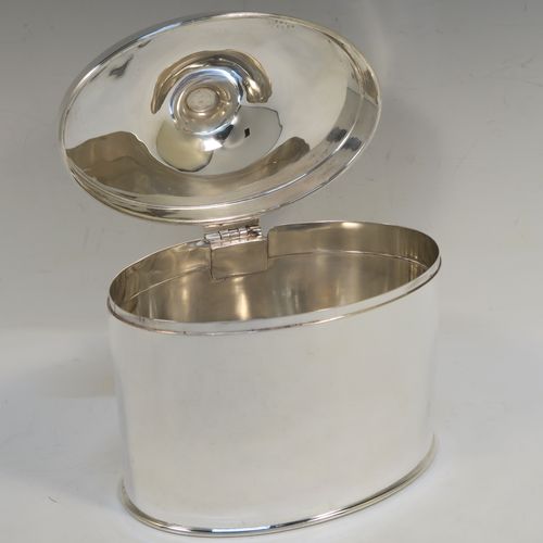 A large and very handsome Antique Edwardian Silver Plated table box, having a very plain oval body with straight sides, a hinged lid with a cast urn-shaped finial, and all sitting on a flat base. This elegant antique table box was made in ca. 1910. The dimensions of this fine hand-made antique silver-plated table box are height 17 cms (6.75 inches), width 17 cms (6.75 inches), and depth 10 cms (4 inches).