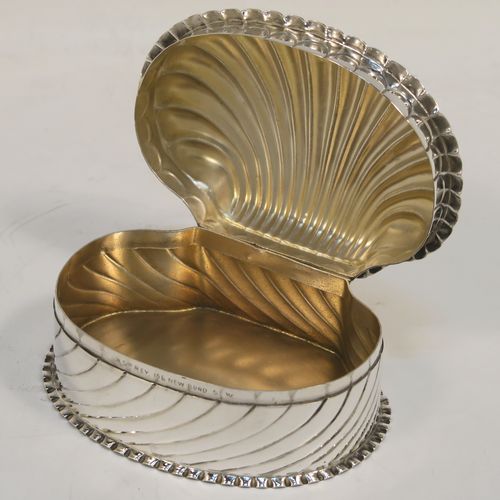 A very pretty Antique Victorian Sterling Silver shell style box, having a shell-shaped oval body with a gold-gilt interior, with hand-chased swirl fluted decoration, a hinged lid, and sitting on a flat base. This beautiful antique silver shell box was made by Horton and Allday of Birmingham in 1888. The dimensions of this fine hand-made antique silver shell style box are length 7.5 cms (3 inches), width 6 cms (2.3 inches), height 4 cms (1.5 inches), and it weighs approx. 57g (1.8 troy ounces).   