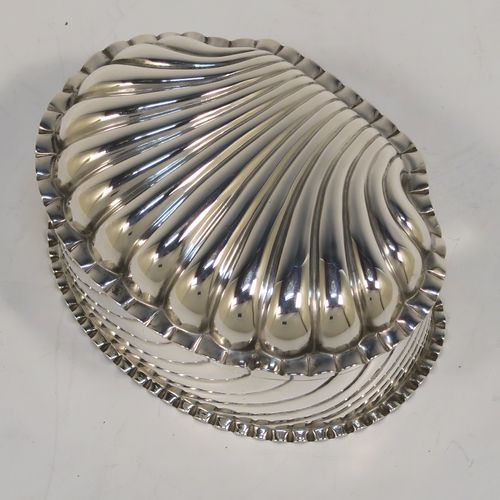 A very pretty Antique Victorian Sterling Silver shell style box, having a shell-shaped oval body with a gold-gilt interior, with hand-chased swirl fluted decoration, a hinged lid, and sitting on a flat base. This beautiful antique silver shell box was made by Horton and Allday of Birmingham in 1888. The dimensions of this fine hand-made antique silver shell style box are length 7.5 cms (3 inches), width 6 cms (2.3 inches), height 4 cms (1.5 inches), and it weighs approx. 57g (1.8 troy ounces).   