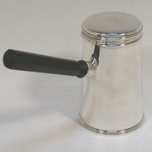 A very unusual and handsome Antique Victorian Sterling Silver brandy or sauce warmer, having a plain round body with tapering sides and reeded borders, a panelled wood turned side handle, a flat hinged lid, and all sitting on a flat base. This elegant antique silver brandy or sauce warmer was made by Alfred Brownett for Aspreys of London in 1866. The dimensions of this fine hand-made brandy sauce warmer are height of main body 11 cms (4.3 inches), diameter at base 7 cms (2.75 inches), length (inc. handle) 15 cms (6 inches), and it weighs approx. 210g (6.8 troy ounces). Please note that this item is crested.