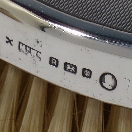 A very handsome Sterling Silver pair of gentle-mans hair brushes, having rectangular bodies with rounded corners, with engine-turned decoration and central vacant round cartouches, together with original pig bristles set into lacquered wooden bases. Made by Mappin and Webb of London in 1952. The dimensions of this fine pair of hand-made gentlemans hair brushes are length 12 cms (4.75 inches), and width 7 cms (2.75 inches).  