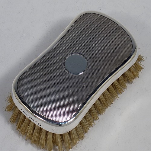 A very handsome Sterling Silver pair of gentle-mans hair brushes, having rectangular bodies with rounded corners, with engine-turned decoration and central vacant round cartouches, together with original pig bristles set into lacquered wooden bases. Made by Mappin and Webb of London in 1952. The dimensions of this fine pair of hand-made gentlemans hair brushes are length 12 cms (4.75 inches), and width 7 cms (2.75 inches).  