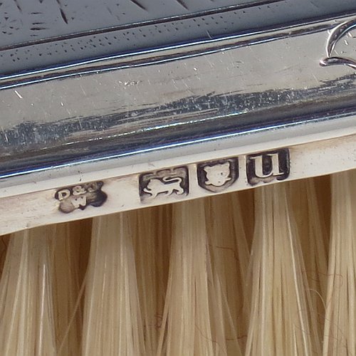 An Antique Sterling Silver hand hair brush, being a copy of a Queen Anne set, having an elongated hexagonal body with panelled handle, all hand-engraved in a Chinoiserie style, and with original bristles. Made by D. & J. Welby of London in 1915. The dimensions of this fine hand-made antique silver hair brush are length 25 cms (9.75 inches), and width 9 cms (3.5 inches).