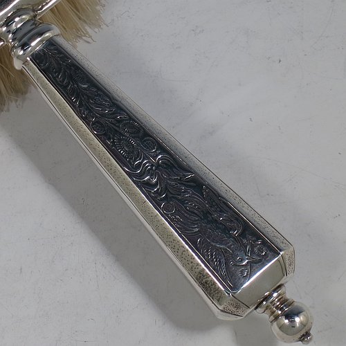 An Antique Sterling Silver hand hair brush, being a copy of a Queen Anne set, having an elongated hexagonal body with panelled handle, all hand-engraved in a Chinoiserie style, and with original bristles. Made by D. & J. Welby of London in 1915. The dimensions of this fine hand-made antique silver hair brush are length 25 cms (9.75 inches), and width 9 cms (3.5 inches).